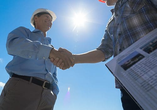 Image of a person shaking hands with a builder