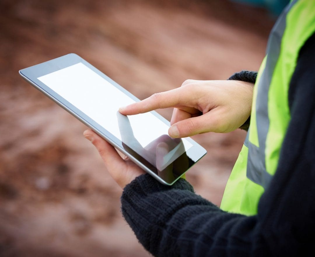construction worker using tablet, close up