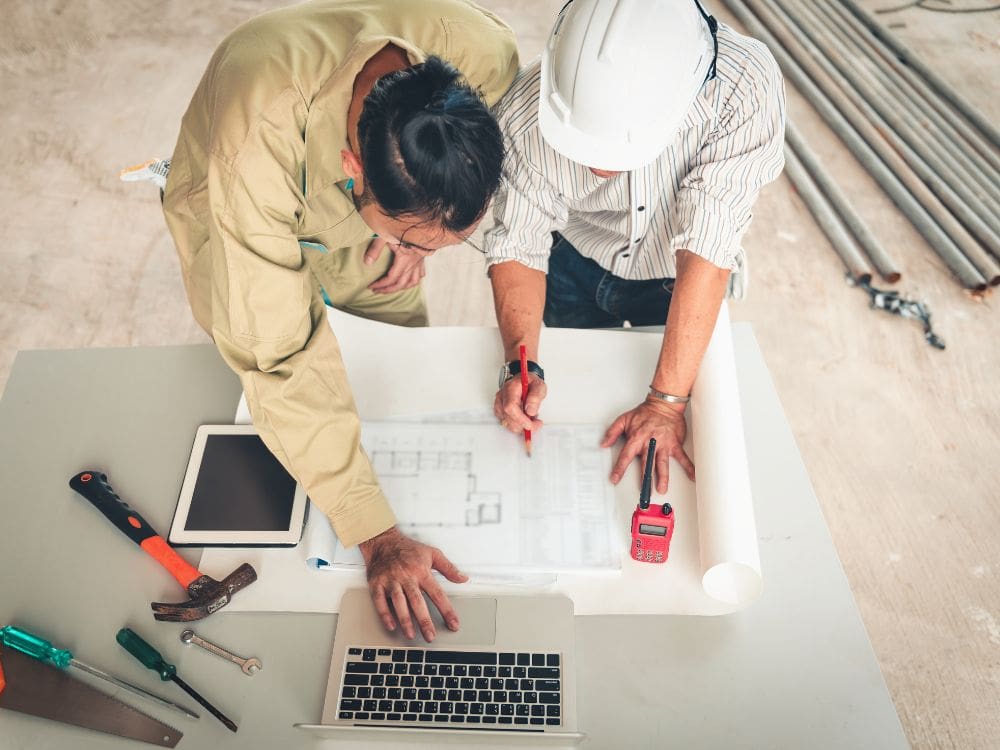 construction team reviewing plans on tablet