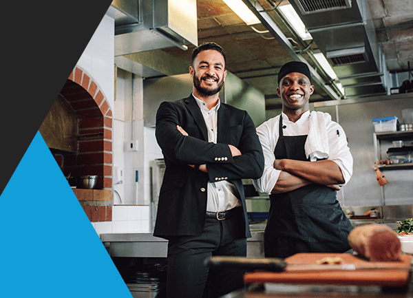 restaurant owner and employee in kitchen